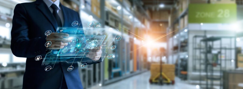 Equipe conferindo mercadorias e dados operacionais em armazém logístico.